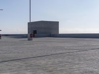 parking lot with multiple lights and street signs in empty setting on flat surface under clear skies