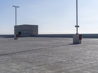 parking lot with multiple lights and street signs in empty setting on flat surface under clear skies