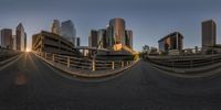 a large city is shown as a fisheye lens captures the movement of a person's body in front of them