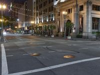 the street in front of the building is empty and quiet at night time, with no traffic or pedestrians