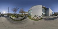 a fisheye lens shows a photo of a building outside by itself with a blue sky