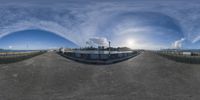 a 360 - cam view of an empty parking lot, with the reflection of a boat in the middle