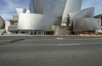 a large building with silver color and a lot of windows on it's side