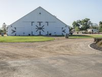 a barn with windows in the front has a large clock on it that says'happy new year 2019 '