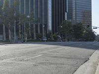 a person walking down a deserted city street with skyscrapers in the background in the daytime