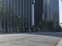 a person walking down a deserted city street with skyscrapers in the background in the daytime