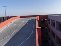 two skateboards parked on a long concrete road with a ramp in the distance and in the foreground