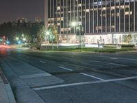 the light in this photo shines brightly on a city street at night and is changing colors