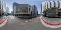 a photo taken in 360 - angle to see the traffic in a city with tall buildings