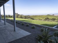 view of rolling green hills from outdoor deck in desert area of winery estate patio and covered patio with blue sky