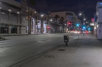 a empty city street at night with no cars to traffic on it's side
