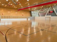 a gymnasium that is made out of wood and with a basketball court inside the center