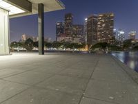 a view of the lights from a city at night with no people around it on the sidewalk