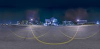 a large city street in front of the skyline of minneapolis, at night as seen from an empty street