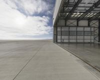 the empty building of an airport has only one car parked outside it to the right