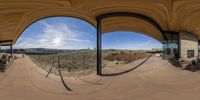 a panoramic view shows the sky and mountains from an outdoor deck at an outdoor area