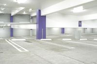 a parking garage with multiple floor and white walls and ceilings and purple beams and a painted ceiling