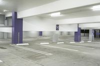 a parking garage with multiple floor and white walls and ceilings and purple beams and a painted ceiling