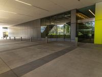 a long hallway in an office building with glass doors and no people inside of it