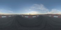 a person is walking around the track in a large circle with stripes and a sky background