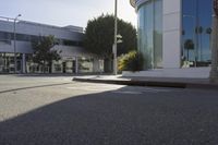 an empty street is shown with signs painted on the pavement along it with trees and buildings in the background