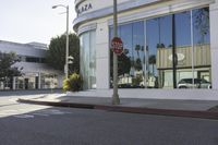 an empty street is shown with signs painted on the pavement along it with trees and buildings in the background