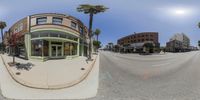 a fisheye view of a street corner and a store across the street from it