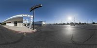 a photo taken through an upside down lens with the sky in the background and road pavement