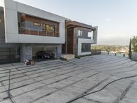 the exterior and landscape of a modern house in los angeles, california with stone and wood