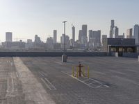 this is a parking lot next to a cityscape with tall buildings in the background