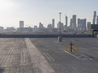 this is a parking lot next to a cityscape with tall buildings in the background