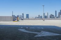 a parking lot with a sign saying we love nyc on it, with the skyline in the background