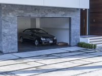 the exterior and landscape of a modern house in los angeles, california with stone and wood