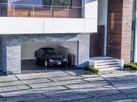 the exterior and landscape of a modern house in los angeles, california with stone and wood