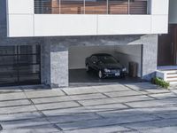 the exterior and landscape of a modern house in los angeles, california with stone and wood