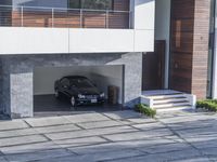 the exterior and landscape of a modern house in los angeles, california with stone and wood