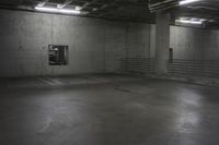 an empty storage room in an industrial building with light coming from the window above the ceiling