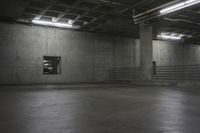 an empty storage room in an industrial building with light coming from the window above the ceiling