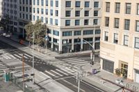 a parking lot has two parking meter and two red telephone booths in it, the city behind it