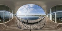 a fish eye looking out into an inner body of water with some boats docked on it