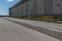 the empty road is near the building and power lines, as if to call it a stoplight