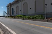 the empty road is near the building and power lines, as if to call it a stoplight