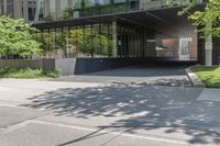 there is a yellow light post on the sidewalk in front of a building that looks like a tunnel