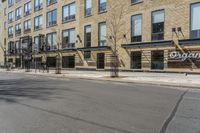 a street in the city with buildings and fire escape stairs on either side of the road