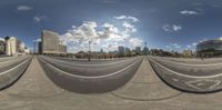 this is a fisheye panoramic view of a cityscape in a 360 camera lens