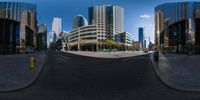 a street with buildings behind a city street in the sun, reflected in this reflective lens