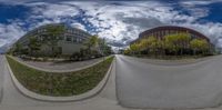 this is a fisheye lens of an office building and the road in the background