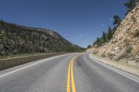 the road is curved at different points of view in this photo and is empty by itself