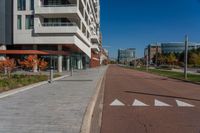 the city street is empty of cars and no people on the sidewalk or bikes on the side