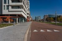 the city street is empty of cars and no people on the sidewalk or bikes on the side